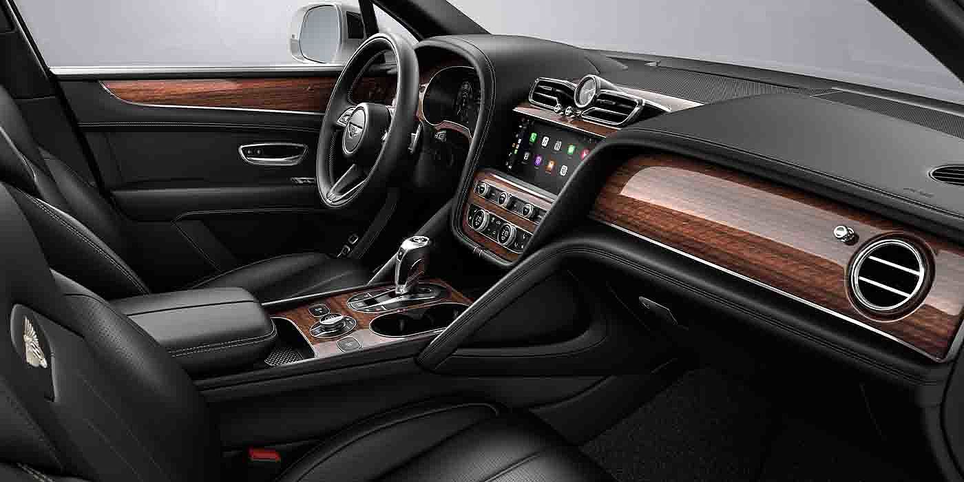 Bentley Jinhua Bentley Bentayga EWB interior with a Crown Cut Walnut veneer, view from the passenger seat over looking the driver's seat.